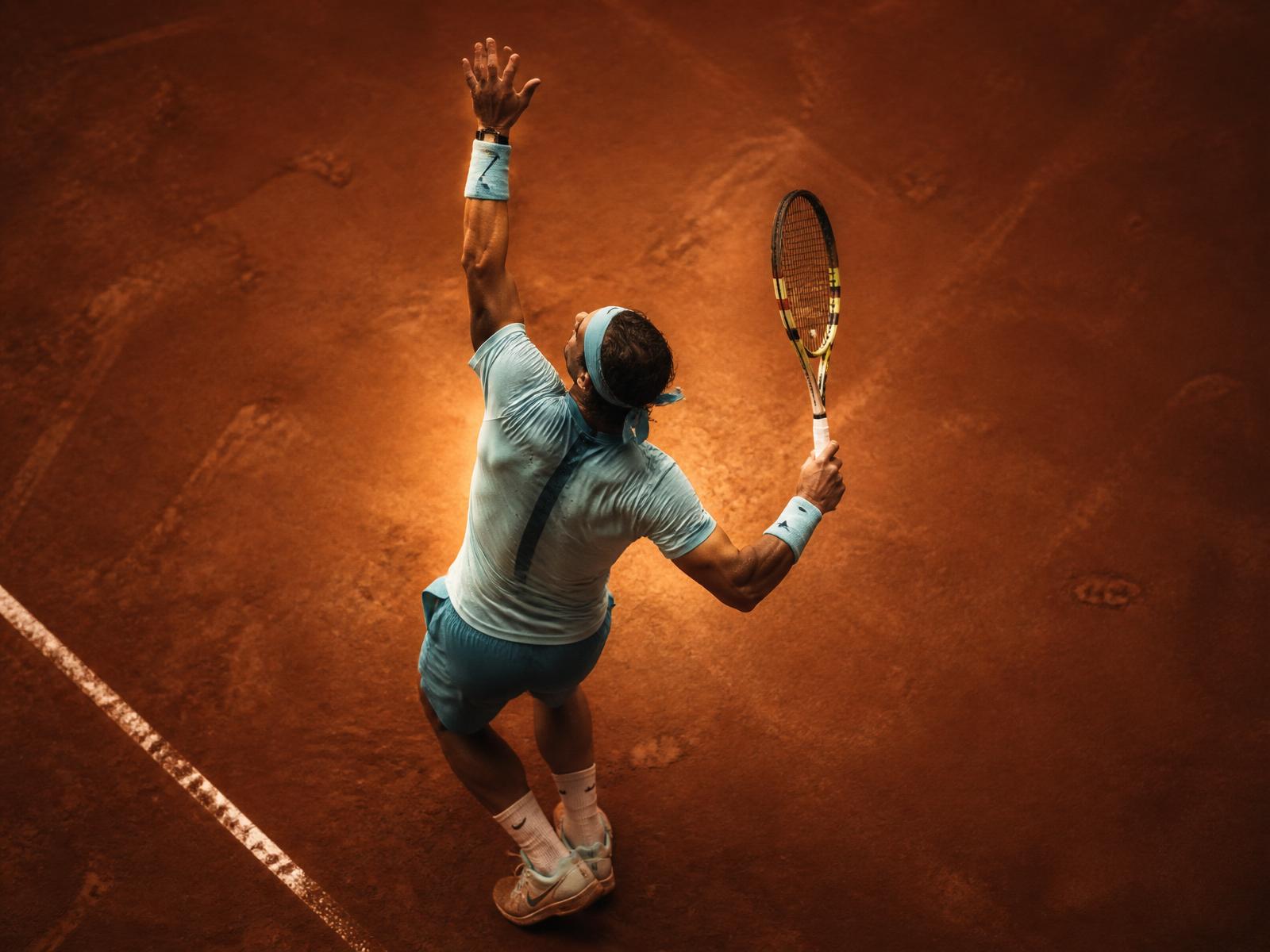 Tennis player on orange clay court